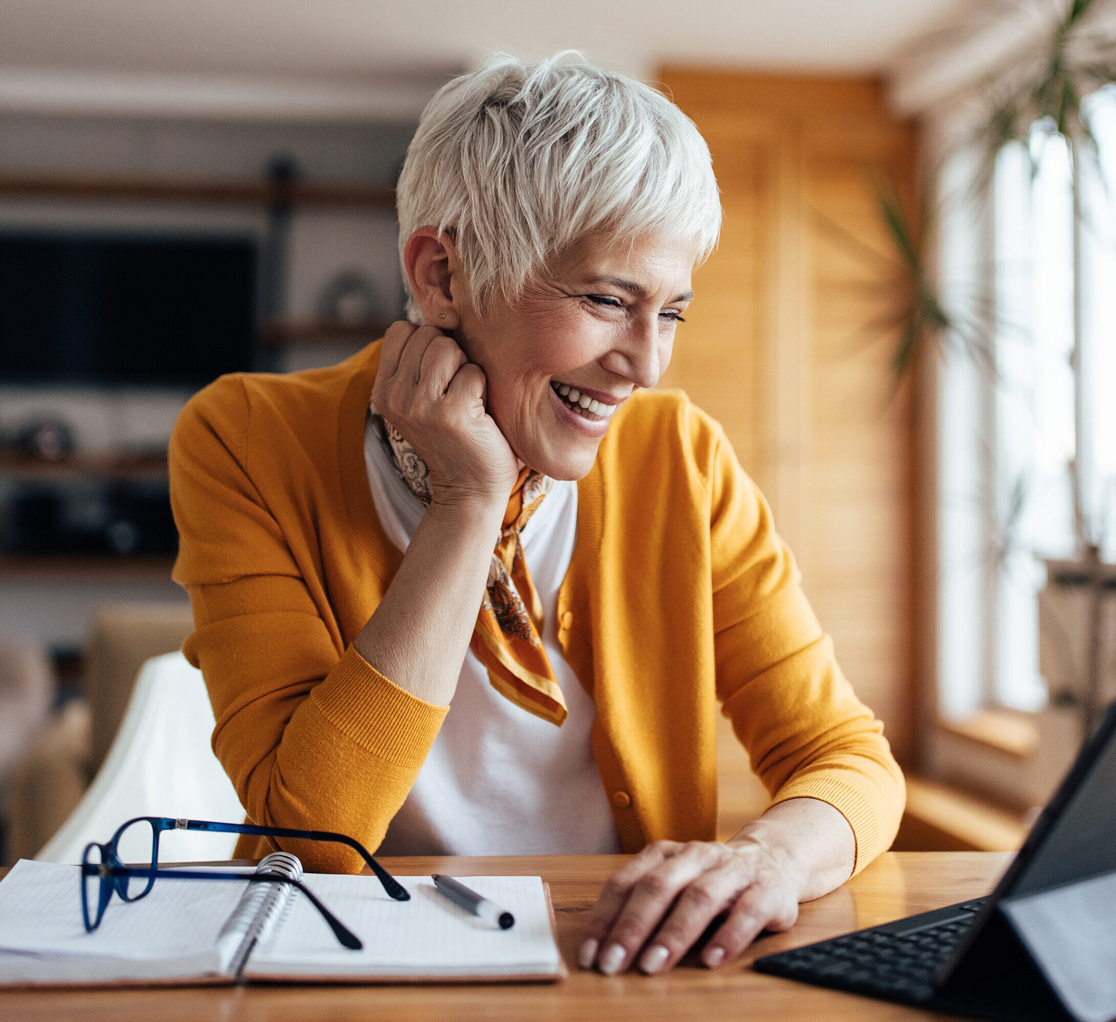 A Black Mountain employee talking on laptop with client with a smile.