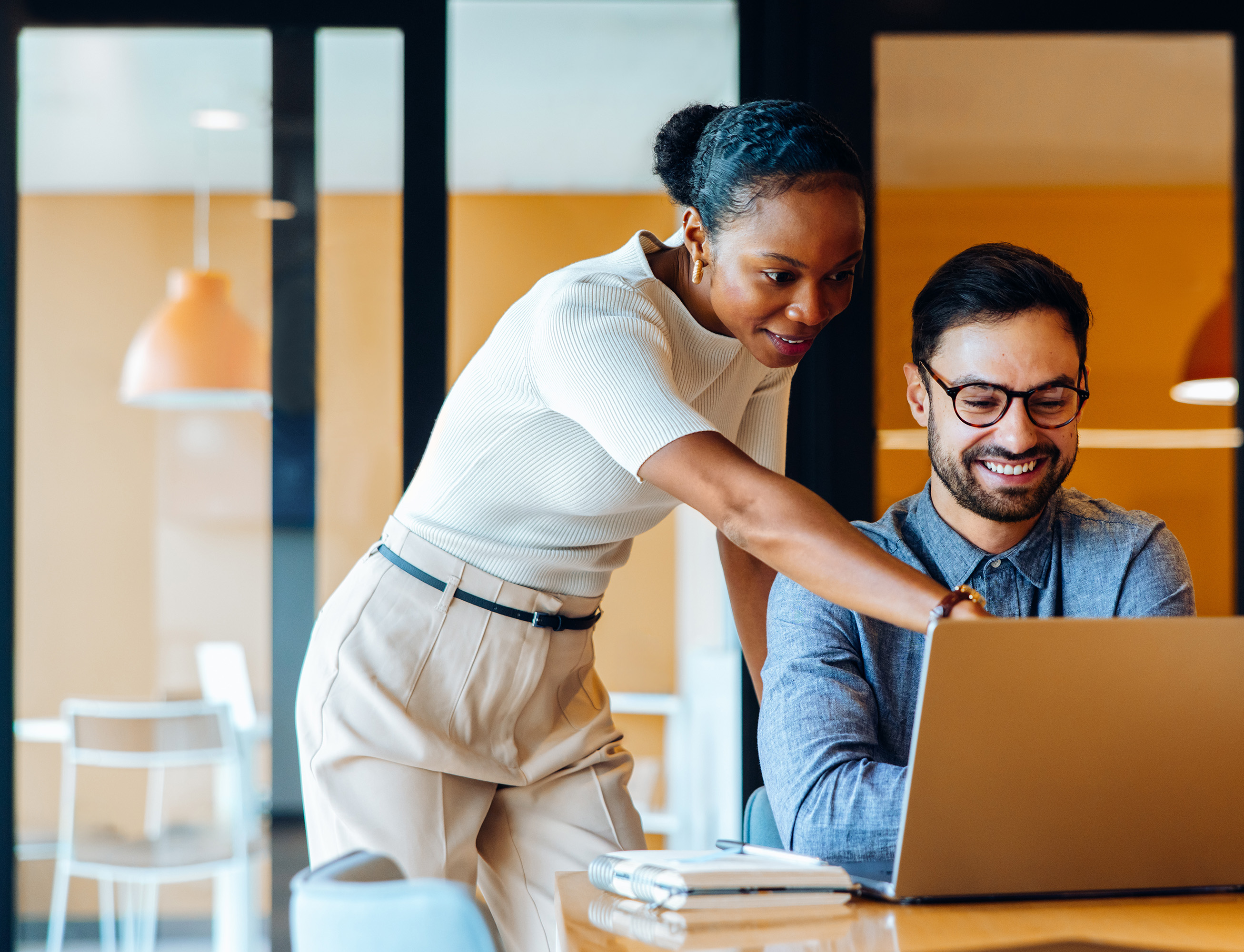Two colleagues looking at their employee benefits offering and package and realising that their healthcare benefits are included.